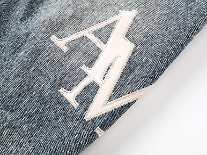 AMIRI Light Blue Distressed Appliqué Jeans — detail