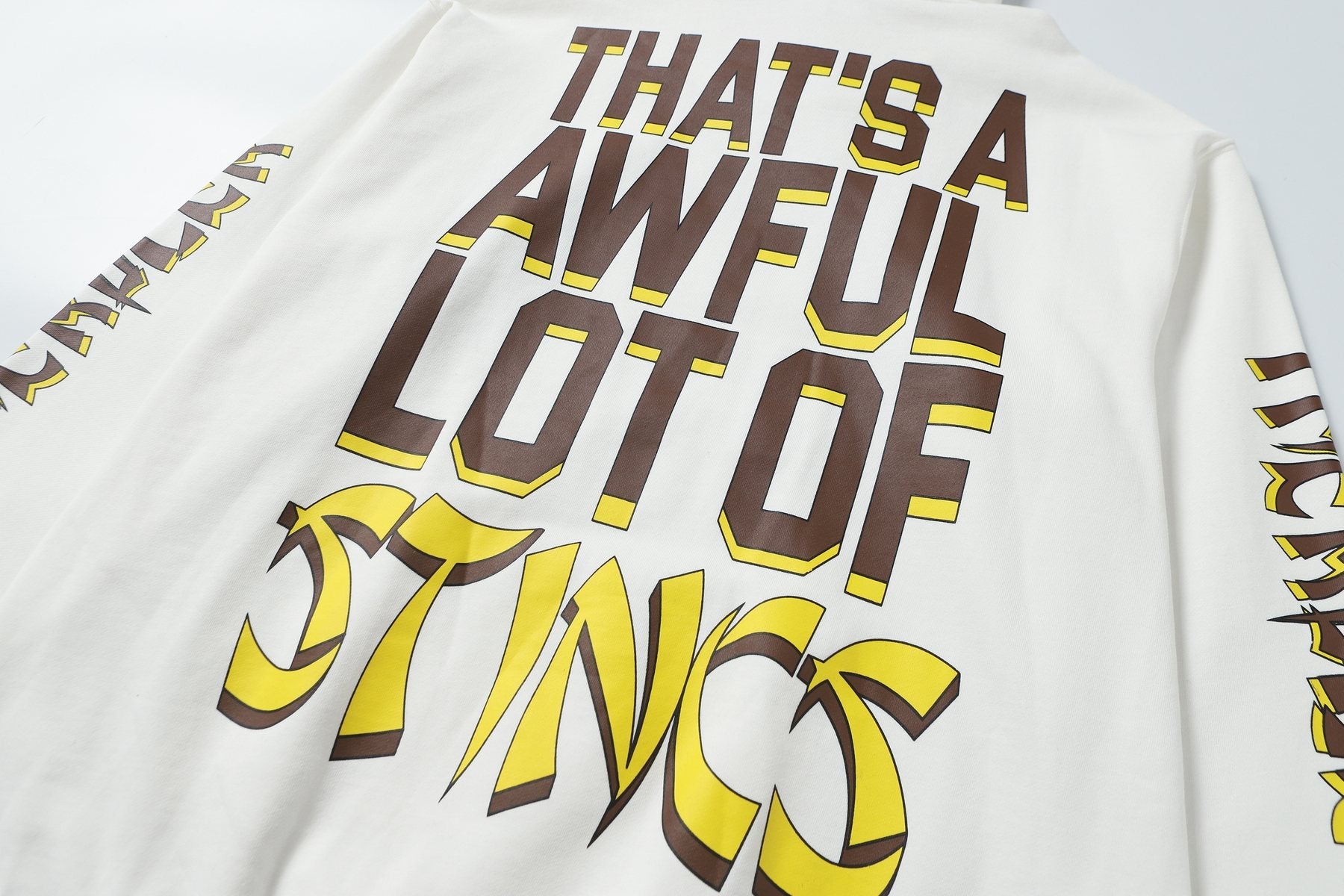 THAT'S A AWFUL LOT OF COUGH SYRUP Stings Character Graphic Hoodie — detail