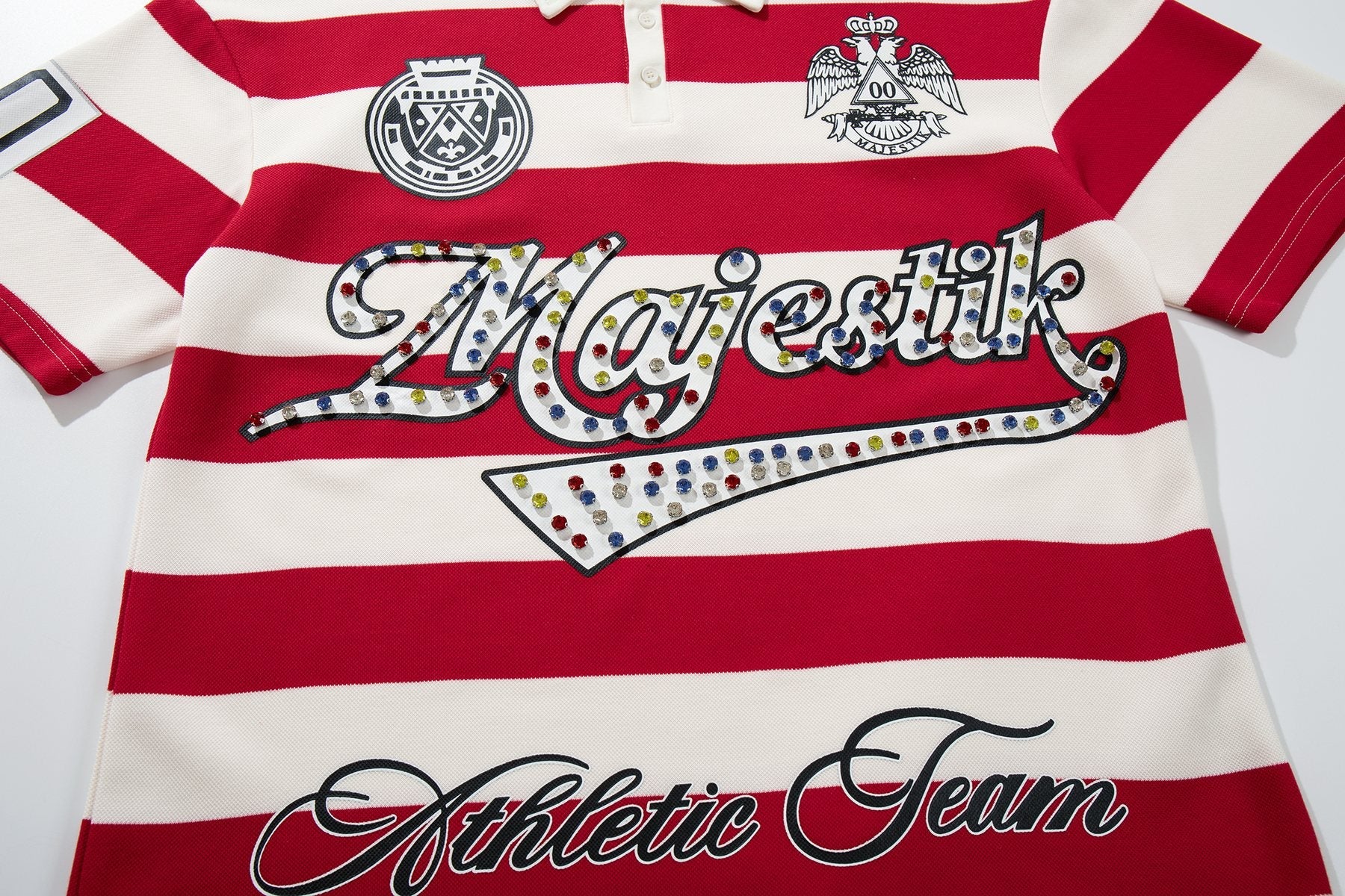 MAJESTIK Striped Crest Graphic Polo Shirt — front