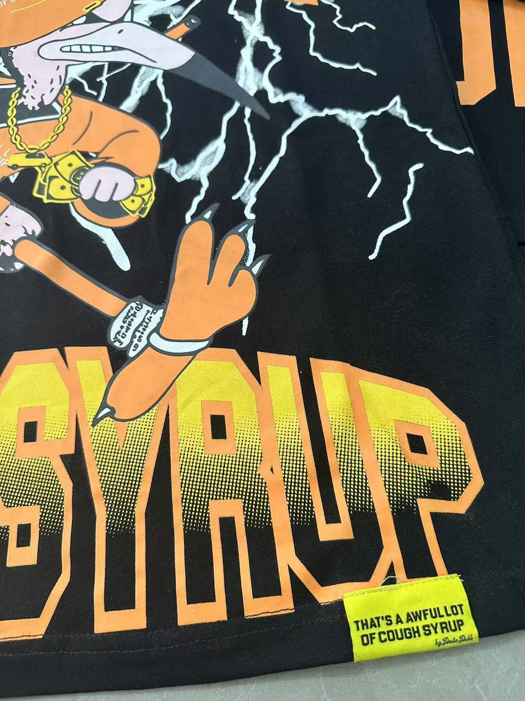 THAT'S A AWFUL LOT OF COUGH SYRUP Lightning Cartoon Graphic T-Shirt — detail